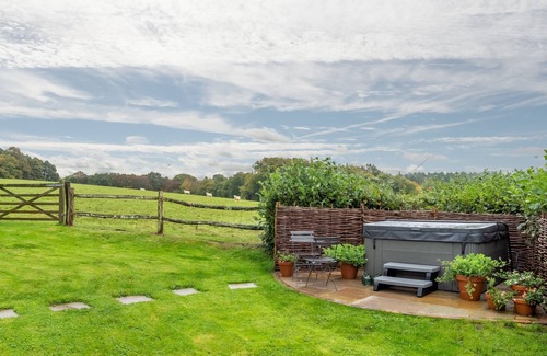 Robertsbridge Cottage | A light and airy property with a hammock and hot tub, situated on a working farm