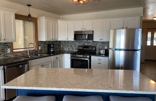 Spirit Lake House | Beautiful sunsets on sand beach of Big Spirit Lake front home!