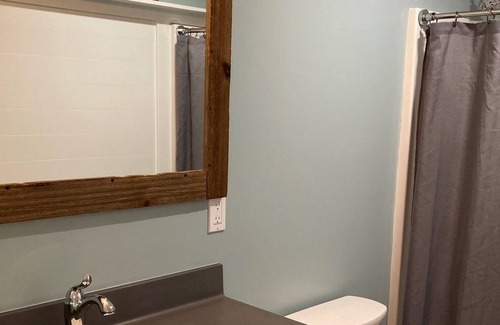 Ludington Apartment | Beautiful wooded area right outside your door and a 5 minute walk to Hamlin Lake