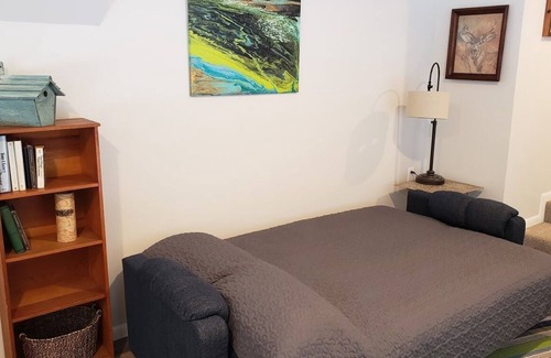 Ludington Apartment | Beautiful wooded area right outside your door and a 5 minute walk to Hamlin Lake