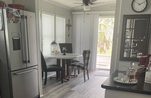 Charlotte Park House | Bedroom with a queen size bed and bath. Shared kitchen and lanai.