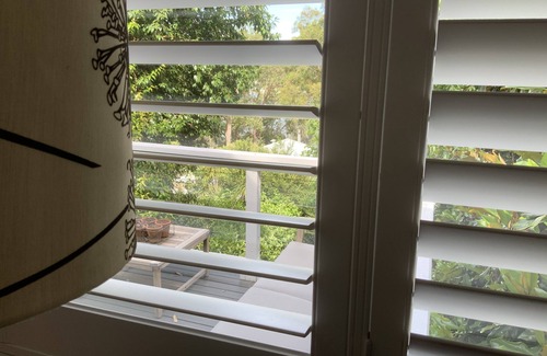 Pretty Beach Apartment | BIRDSONG Stylish private couples loft with water glimpses through the treetops.