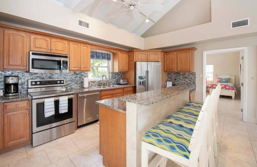Old Man Bay House | Cayman Sands: Secluded Beach Villa with Pool Atrium & Guest Cottage