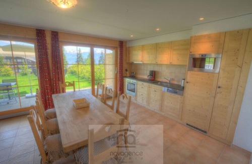 Anzere Apartment | Contemporary flat with a garden. Warmly decorated; a large living room with a dining room and a bea