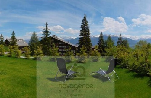 Anzere Apartment | Contemporary flat with a garden. Warmly decorated; a large living room with a dining room and a bea