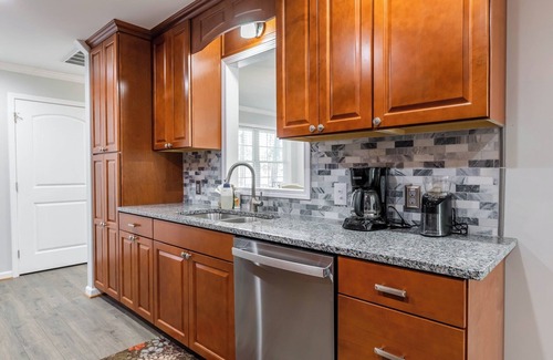 Radford House | Cozy home with a modern kitchen, spacious living, serene bedrooms, and a private deck for relaxation