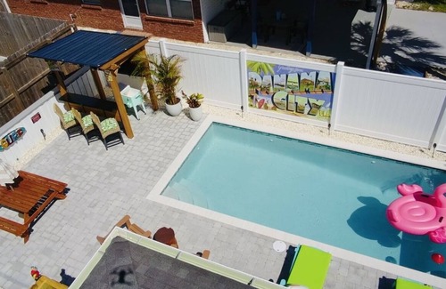 Bel Air House | Cozy Retreat , steps to the beach, heated pool , gulf views & huge party Deck