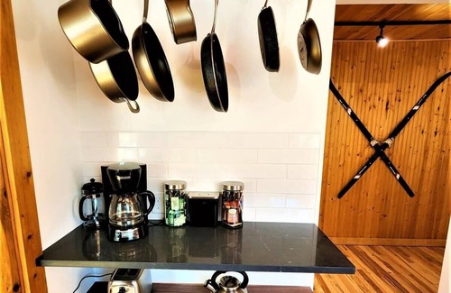 Traverse City Cottage | Creekside Hot Tub|Walk to Beach|Uniquely Northern