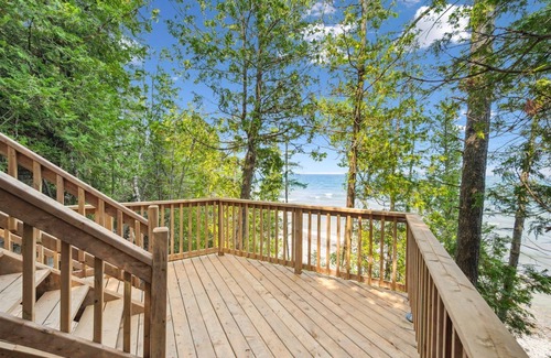 Lion's Head Cabin | Disconnect from it all at Stonewood, a cozy log chalet nestled in cedar forest on Georgian Bay. Enjoy a private shoreline, wraparound deck, wood stove, and access to kayaks, and trails. Peace, comfort, and adventure await in Cape Chin South.