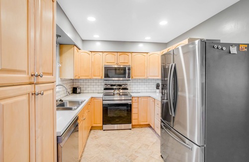 Eagle River House | Dog-friendly home with a fenced yard, putting green, & shared washer/dryer
