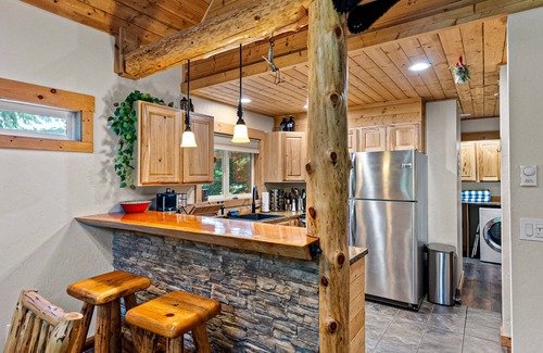 Snoqualmie Pass Cabin | Dog-friendly riverfront cabin with deck, hot tub, gas fireplace, & game room