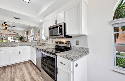 Caloosahatchee Villa | Enchanting tropical waterfront villa with boat slip, bikes, kayaks heated pool!