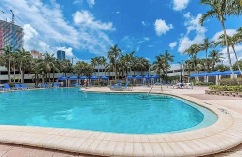 Aventura Condo | Entire condominium with a pool view, steps from the beach