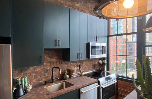 Seaport District Apartment | Fort Point Corner of Windows brick & beam loft