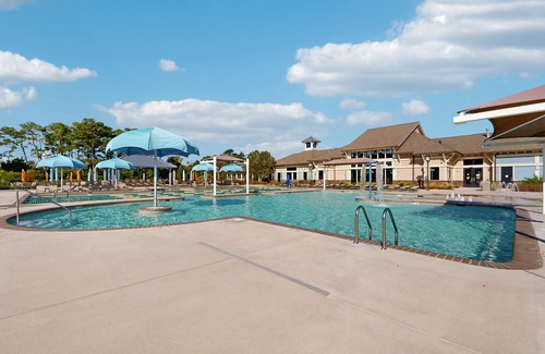 West Beach House | Gorgeous Bay Forest home with resort amenities, raised patio, office, & firepits