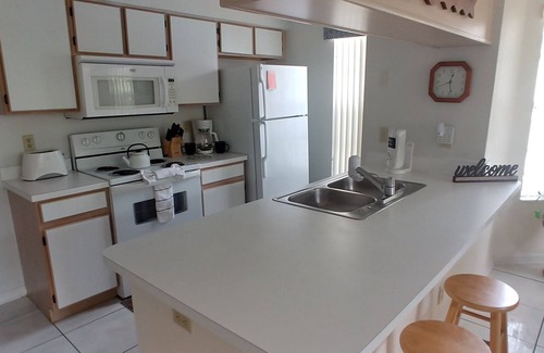 Royal Palm Bay Condo | Ground floor, With a pond view patio.