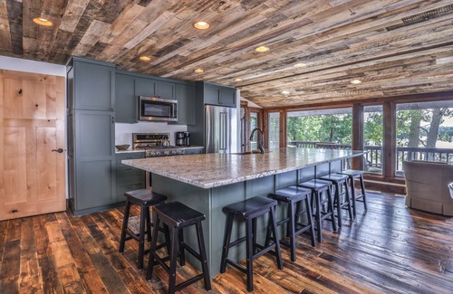 Presque Isle Cabin | Lakefront home on snowmobile trail with kayaks/SUP, fireplace, game room & AC