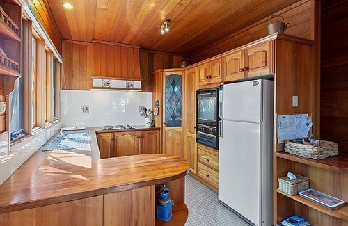Sawmill Settlement Cabin | Lumi Talo - Retro quintessential two-story cedar lodge