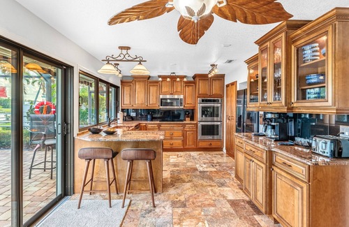 Cocoa Isles House | Luxury Canalfront Home w/Heated Pool, Game Room, Boat & Jet Ski Lifts