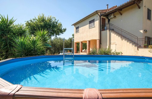 Magliano in Toscana House | Move into a functional holiday apartment with a garden and communal pool.