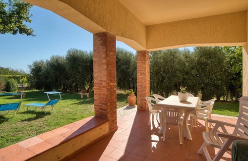 Magliano in Toscana House | Move into a functional holiday apartment with a garden and communal pool.
