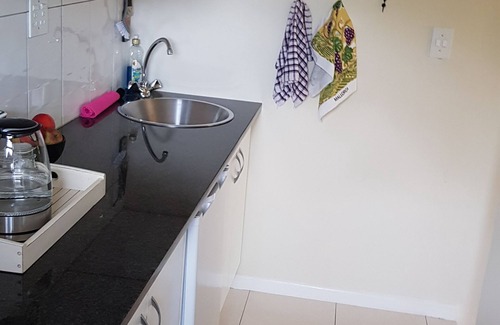 Somerset West House | Neat, modern, comfy and secure apartment with a leafy garden and parking.