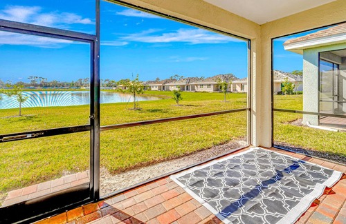 Venice House | Newly built, single-story home on a lagoon with a porch, pool and bocce courts
