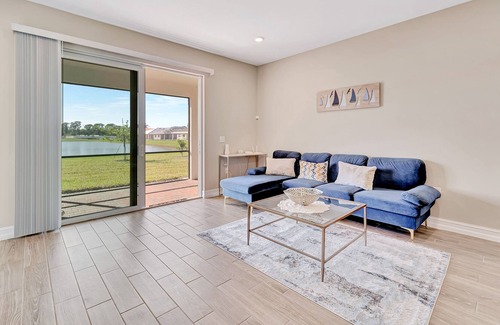 Venice House | Newly built, single-story home on a lagoon with a porch, pool and bocce courts