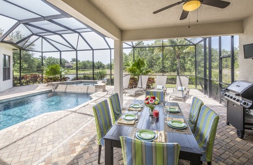 Central Naples House | overlooking a nature preserve and lake, this pool with spa home has it all
