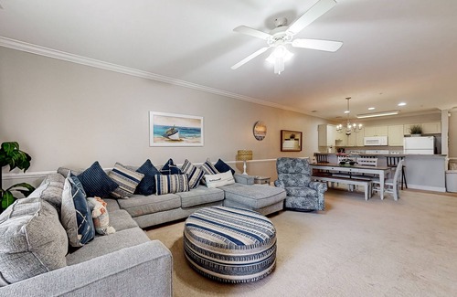 Central Myrtle Beach Condo | Quiet golf community with security, covered balcony, W/D, AC, & pool access