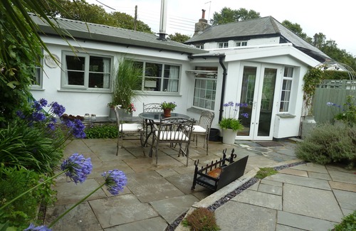 St Issey Cottage | Quirky home with romantic shepherds' hut bedrooms and pretty garden near Padstow