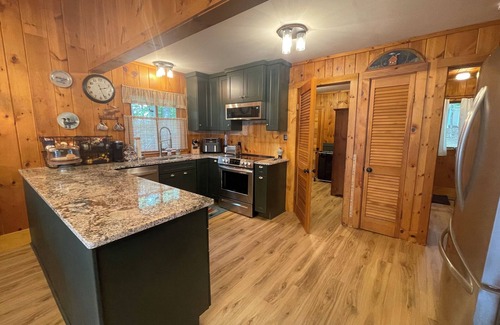 Oxford Cottage | Relax in the glow of a campfire at this waterfront cottage on Thompson Lake