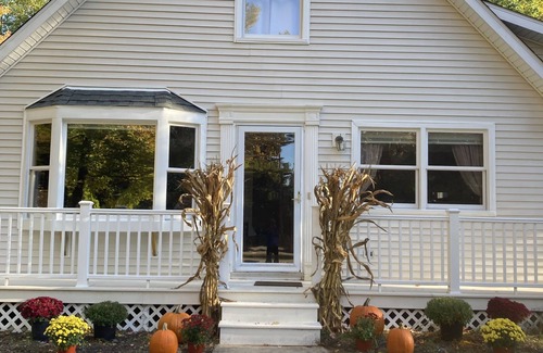Lake House | Roomy home with spacious fenced in backyard and fire pit.