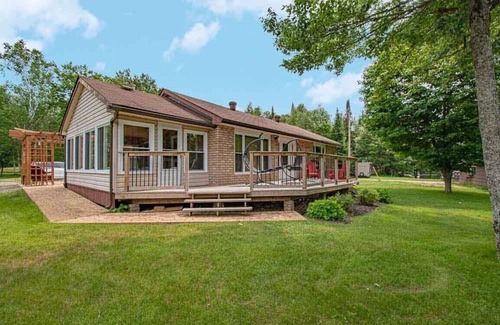 Kearney Cottage | Sand Lake Getaway - Modern Riverfront Cottage w/Swimming & Hot Tub