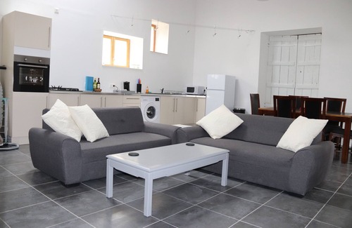 Soumeras House | Spacious, double height, beamed main space. This gite is in a rural setting.