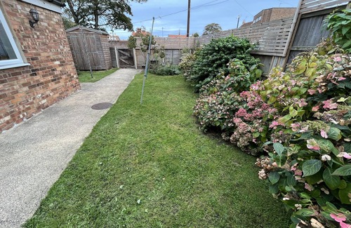 Sheringham Apartment | Spacious home, moments from beach/shops. Private parking, garden. Pet friendly.