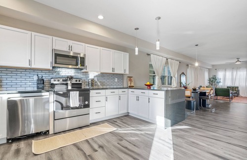 Near Northside Apartment | Stylish 3-Story Home Sleeps 14 Near Monon Trl WiFi, AC + Private Hot Tub