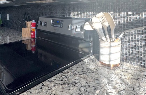 San Angelo House | Stylish corner home with cozy interiors, a private bar, and inviting charm
