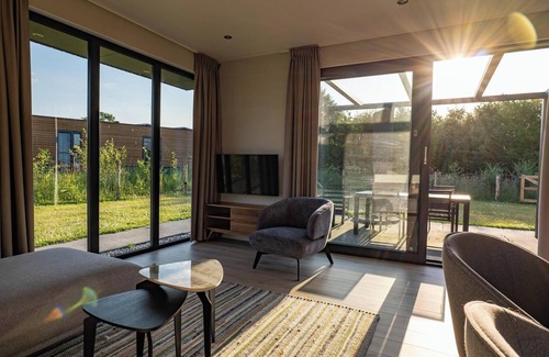 Lattrop House | This holiday home with a fully enclosed dog fence, private sauna and hot tub features a cosy, homely living room with open kitchen, 2 bedrooms and a spacious outdoor area.