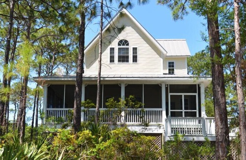 Plantation House | This sweet cottage is fenced by lush, natural landscaping and offers a peek of the Apalachicola Bay.