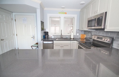 Boyne City Condo | Vaulted Ceilings + Prime Lake Charlevoix Views | Fireplace | Private Patio|