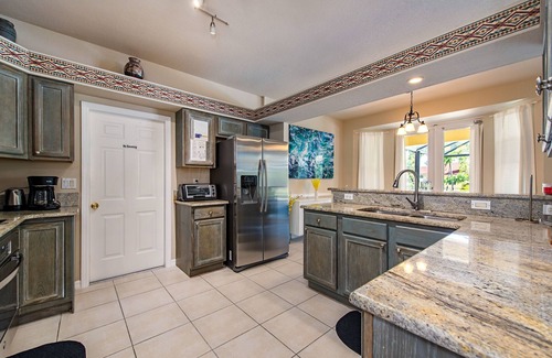 Palm River Estates House | Vibrant home close to best beach parks and shops backyard pool with a lake