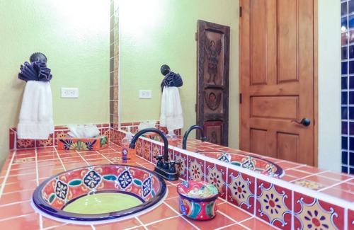 Nopolo House | Vibrant house with golf/ocean views, shared pool, partial AC, WiFi & gas grill!