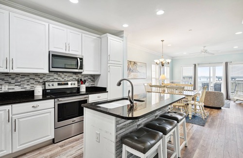 Waters Edge House | Water's Edge 114 - River Daze - Premier Riverfront Townhome - Pool & Fishing Pier!