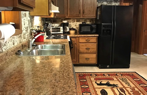 Lac du Flambeau House | Waterfront Lake Lodge with fireplace: Sleeps 10. Pets Ok. Fall Pontoon Specials!