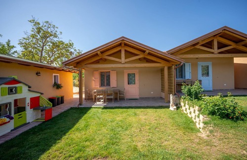San Brizio Apartment | Wooden house with porch and garden