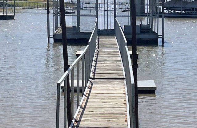 Lake front retreat, covered boat dock, large deck , fenced play area, RV parking