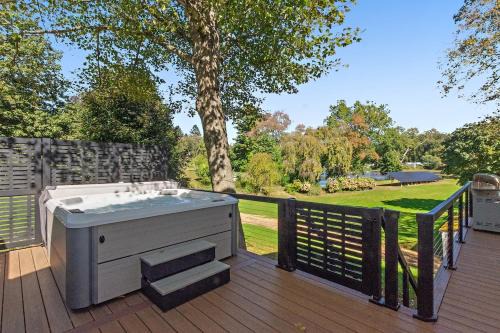 Modern Waterfront Retreat with Hot Tub & Pond Views