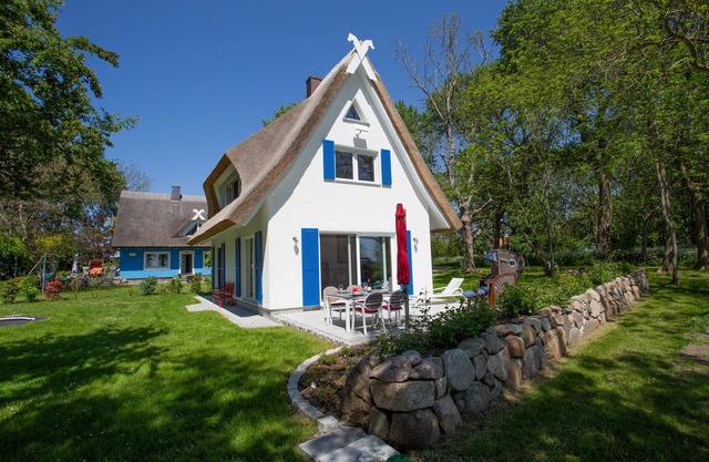 Picturesquely situated thatched-roof house in a large park-like garden