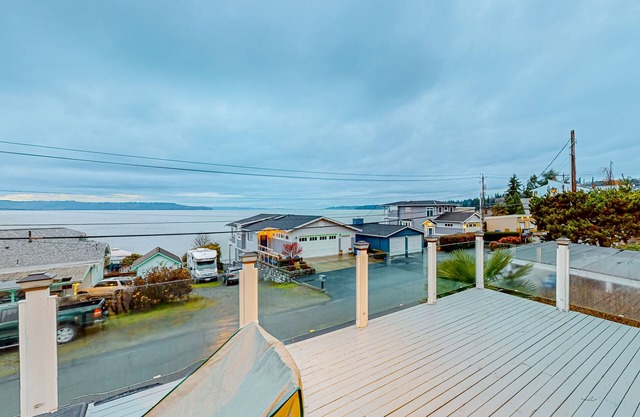 Renovated sound & mountain view home with open layout, grill, & washer/dryer